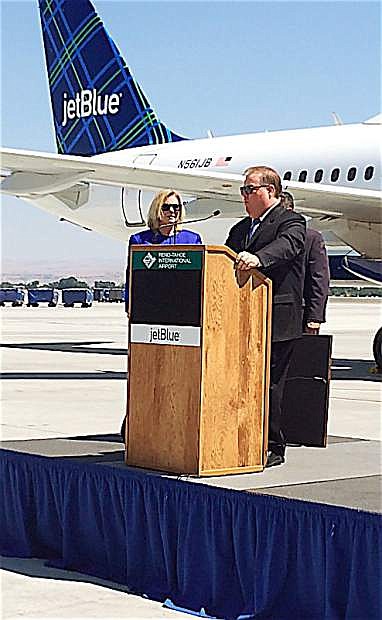 Tom Bert, executive vice president of corporate affairs for Jet Blue, talks Aug. 15 to those welcoming the inaugural flight of the airline&#039;s non-stop flight between Reno and Long Beach, while Marily Mora, president and CEO of the Reno-Tahoe Airport Authority looks on.
