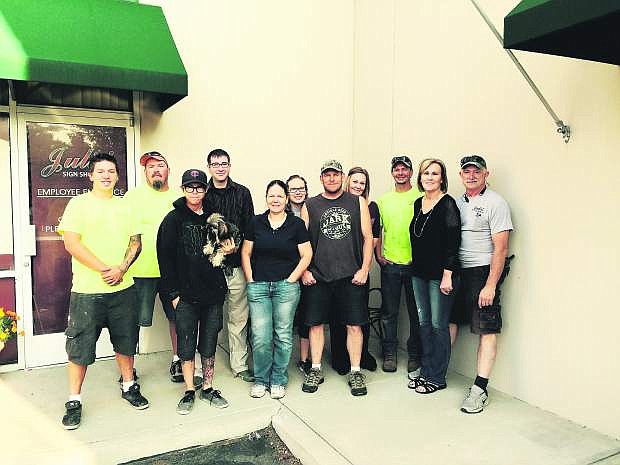 The employees of Julie&#039;s Sign Shoppe in front of their current location on 4579 Longley Ln. The business recently purchased a 13,164-square-foot building which it plans to occupy by the end of 2015.