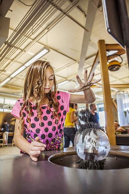 A young visitor to The Discovery explores electromagnetism in the Da Vinci Cornerof Reno&#039;s science museum.
