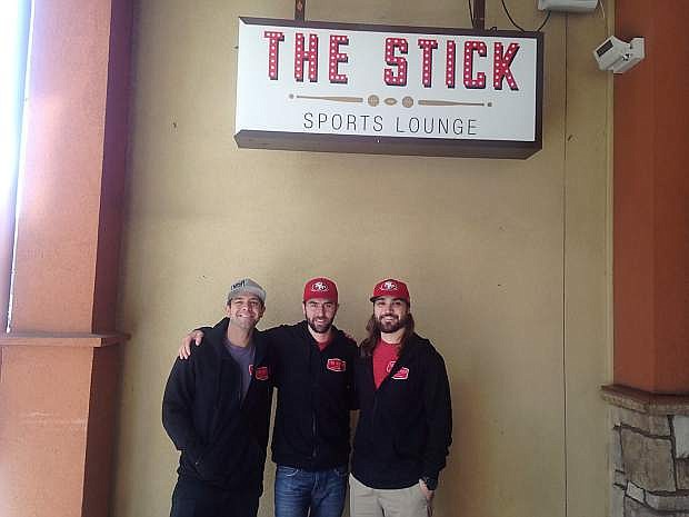 Steve Towell (center), owner and general manager of The Stick Sports Lounge stand outside The Stick alongside Rudy Grant (left) and Ross Elin (right).