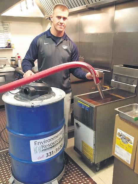 Austin Smock of Easy Rooter Plumbing and its subsidiary, Environmental Resources, inc., displays its mobile deep fryer vacuum.