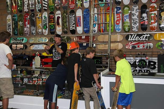Tim Ray works the skateboard counter as customers check out the accessories.
