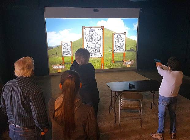 Members of the Northern Sierra Ladies Gun Club attend a target shooting session with the simulator at Carson Guns on 1804 E. William Street.