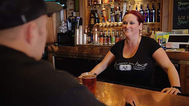 A bartender serves a drink at the Virginia City Brewery &amp; Taphouse.