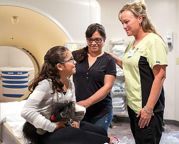 High Desert Imaging&#039;s Jenn Cambra talks to a young patient before a CT scan.
