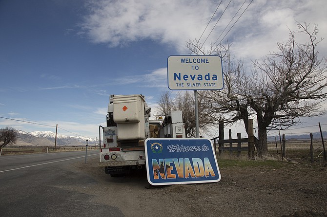 Installation of Welcome to Nevada sign.