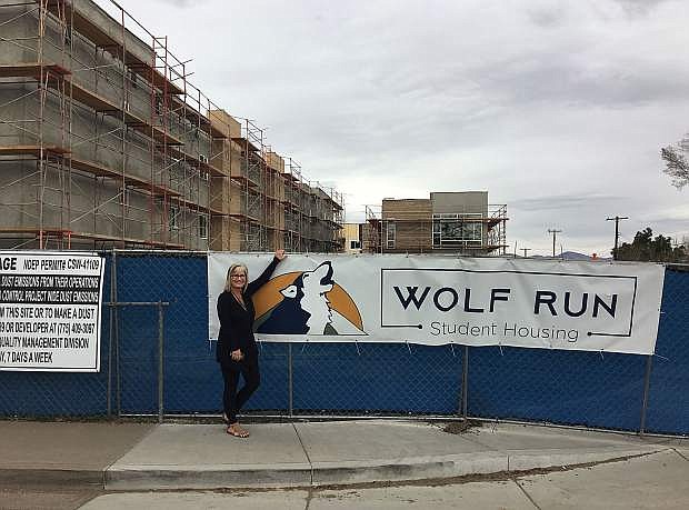 Shellie Neeser-Brown, co-founder of the Wolf Run properties, stands in front of the 105-unit Wolf Run East development. The student housing complex is scheduled to open this August.