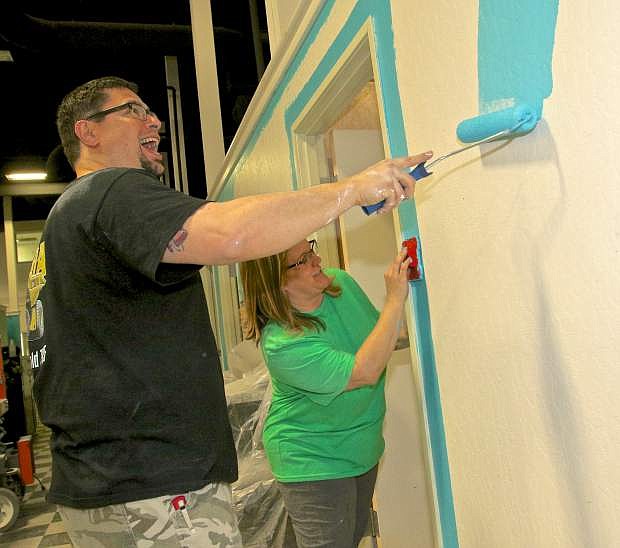 Anthony and Brandy Gayner paint a wall in the soon to be opened beauty school in Carson City.