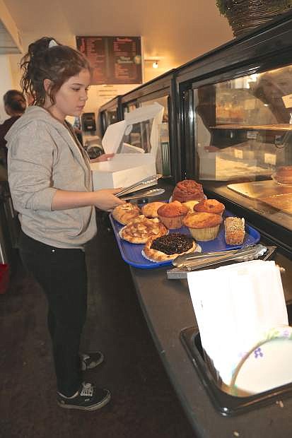 Daelyn Sebold prepares an order of pastries at LA Bakery Thursday morning in Carson City.