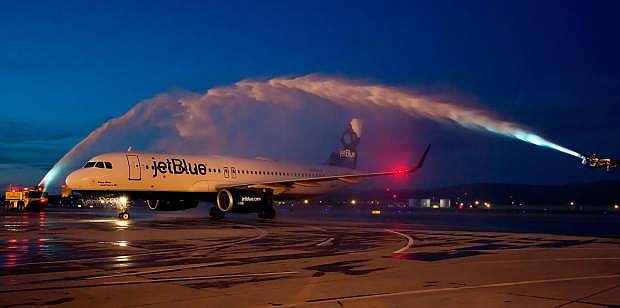 A JetBlue airplane is cleaned on one of the runways at Reno-Tahoe International Airport.