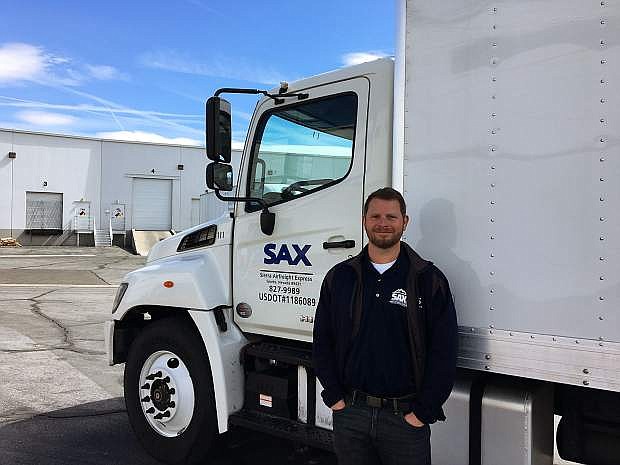 Andy Zarcone, owner and president of Sierra Airfreight Express (SAX), standing in front of one of the company&#039;s trucks.