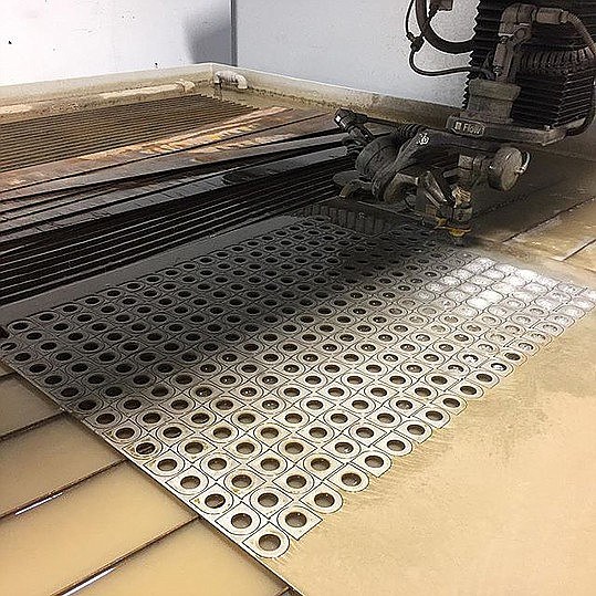 Wade Metal Works added a new Flow 5 axis water jet to their services offered. The 5 axis cutting head is capable of creating angles and bevels that no other machine in the area can achieve. 