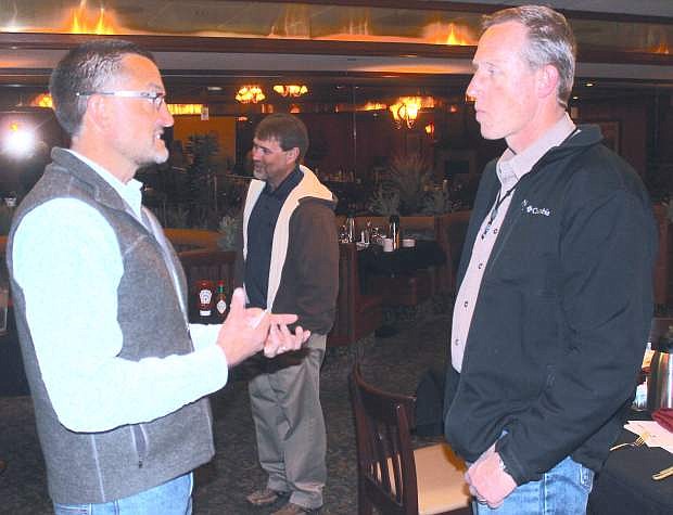 Darryl Bader, left, chief operating officer of ITS Logistics, speaks to Naval Air Station Fallon&#039;sRob Rule, the base&#039;s community plans and liaison officer, after a CEDA breakfast.