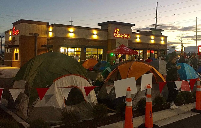 Will it happen here? Fans of Chick-fil-A often camp out and line up when a new restaurant opens, such as in this unidentified town. Chick-fil-A helps them pass the time with contests and activities.