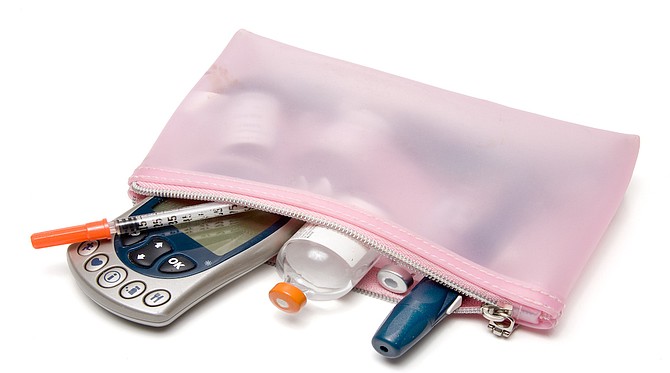 A diabetics glucometer and diabetic testing kit.