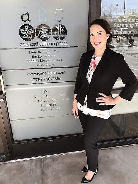Dr. Melissa Perotti stands in front of the entrance to Advanced Health Chiropractic&#039;s office at 9570 S. McCarran Boulevard in Reno.