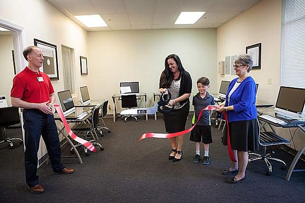 Careen Sibbring, Emmett Sibbring and Chamber Ambassadors Ted Thran of the Town of Minden and Susan Conner of AFLAC cut the ribbon at Smart Staff Training&#039;s open house May 11.