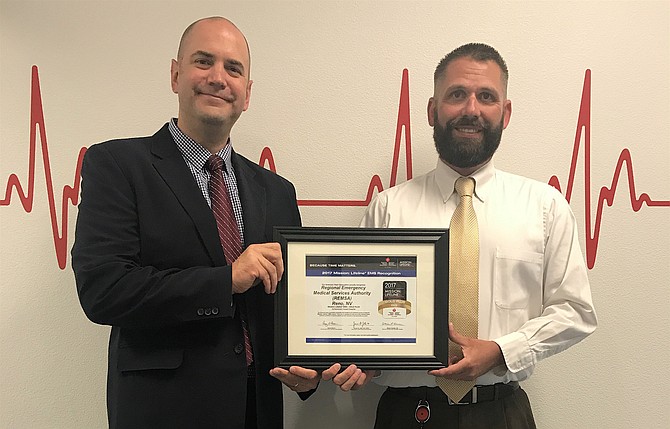 Mick Smith, senior regional director Quality and Systems Improvement, American Heart Association, presents the Mission: Lifeline EMS Gold Plus Award to Jason Hatfield,  Continuous Quality Improvement Coordinator, REMSA. 