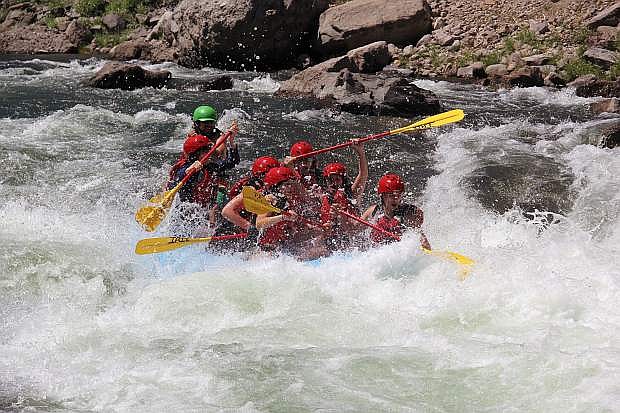 A guide with IRIE Rafting Company takes a group of rafters through rapidson the Truckee River in this file photo.