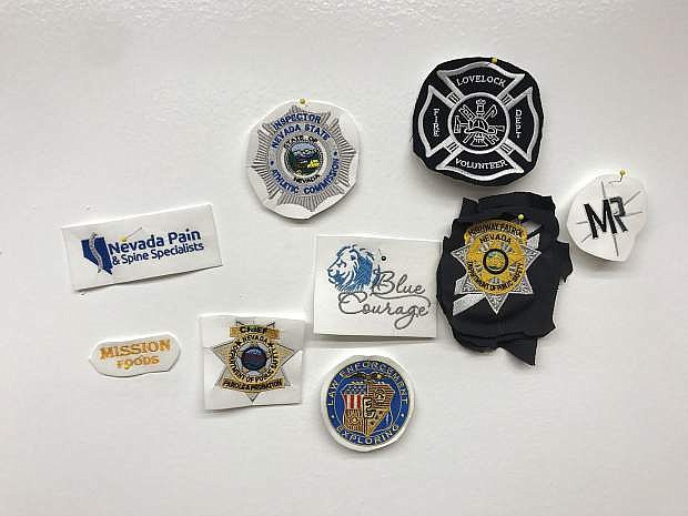Uniform patches for a variety of jurisdictions are seen in the embroidery room at Reno Uniforms &amp; Tactical Store.