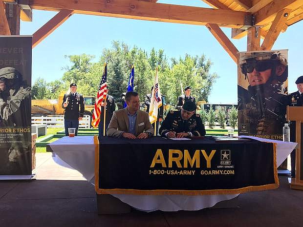 Aaron West, CEO of Nevada Builders Alliance, and Lt. Col. Michael Gomez, commander of the U.S. Army Northern California recruiting battalion, sign the agreement for a new partnership in the U.S. Army PaYS program. The partnership provides job opportunities within the construction industry after completion of their service.