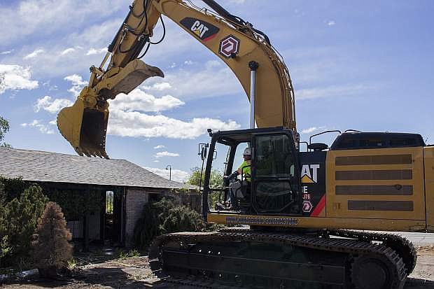A crewmember from Diversified Demolition Company prepares to demolish a portion of the former Wildflower Village.