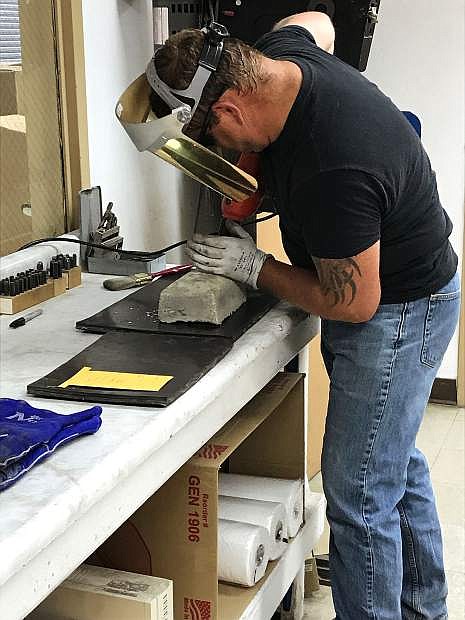 A hole is drilled in a dore bar at Rye Patch Gold&#039;s Florida Canyon Mine to collect samples to send to the assayer to determine the quality of the precious metal.