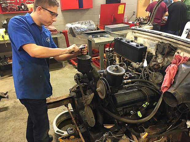 Dominic Cerniglia works on a Cadillac engine during a Western Nevada College Automotive Mechanics class.