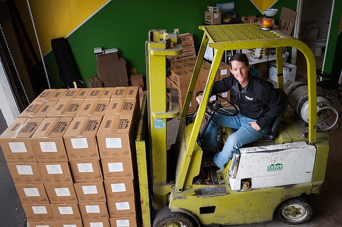 Wes King, owner of Tahoe Trail Bar, moves boxes at the Reno warehouse.