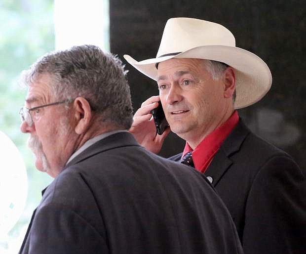 Senator James Settelmeyer takes a call in the lobby during a brief recess on the last day of the 2017 Legislature June 5.