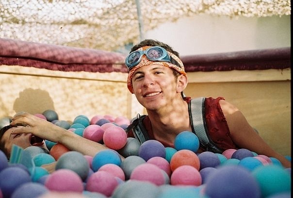 Lucas Pakele swims in the Jacuzzi ball pit at last year&#039;s Burning Man.