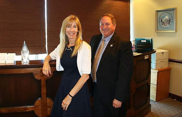 CJ Manthe, left, incoming director of the Nevada State Department of Business and Industry, and former director Bruce Breslow, who is going to the Public Utilities Commission of Nevada, pose in the office of the department.