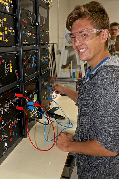 CHS sophomore Jordan Jacoby works on an Electrical Mechanic Simulation Machine Friday in the new manufacturing lab at Carson High.