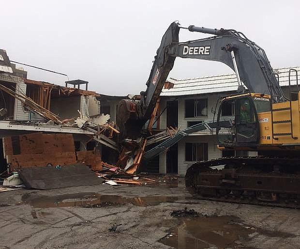 Heavy machinery chews into the old Star Dust Lodge on Arlington Avenue near Fourth Street in downtown Reno to make way for Jacobs Entertainment&#039;s future &quot;Fountain District&quot; development.
