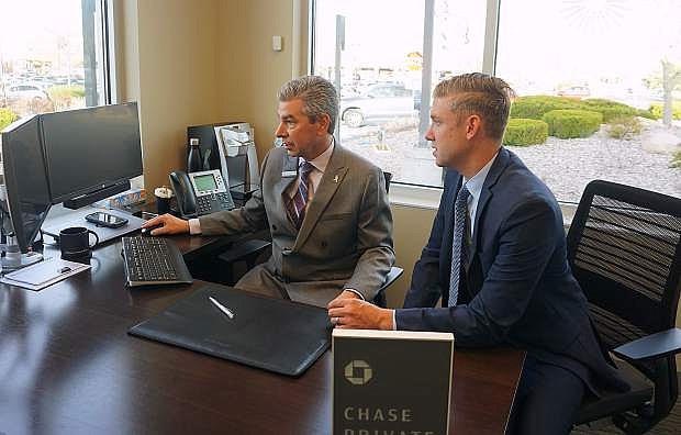 Joseph Tartaglini, vice president and private client adviser, and Sean P. Herron, market director for the Northern Nevada and California region of JPMorgan Chase &amp; Co., discuss how to manage a client&#039;s portfolio at Chase Bank&#039;s new office off of Wedge Parkway in south Reno.