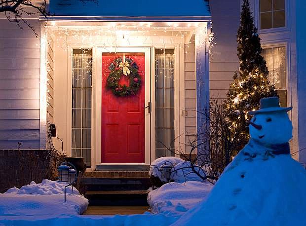 Holiday lighting, whether simple as seen here or more ornate, provides an inviting first impression for home shoppers.