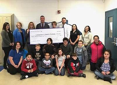 Nevada State Bank and Communities In Schools of Northeastern Nevada employees, pose with Flagview Intermediate School students.