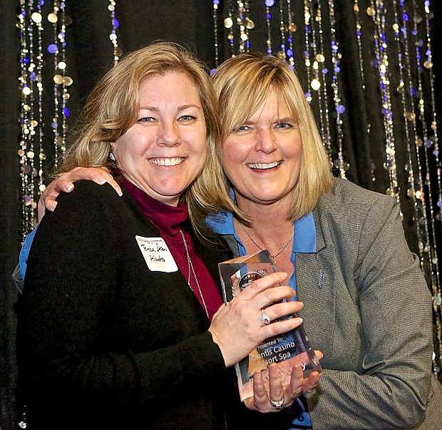 Atlantis Casino representative Teresa Drew accepts the Most Sustainable (Green &amp; Earth-Friendly) award from Stacy Asteriadis of City National Bank at the Jan. 17 gala.