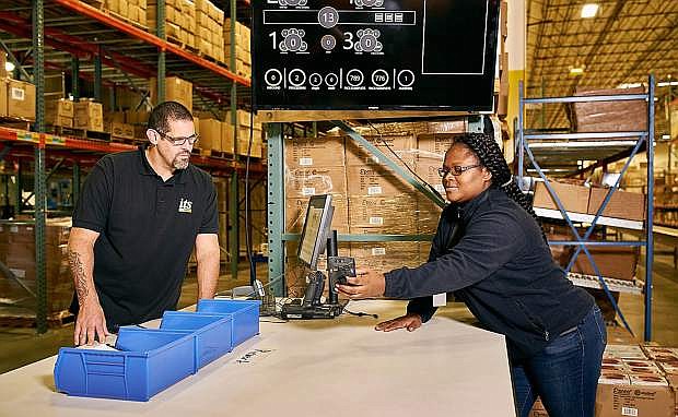 Chris Claudio, left, and Samantha Forbes check inventory scans at the ITS Logistics warehouse in Sparks.