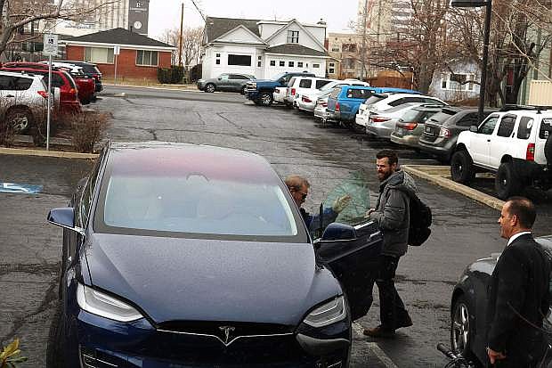 NNBW reporter Kaleb M. Roedel, right, prepares to take a test drive in a Tesla Model X as Guy Hall, director of SacEV, exits the vehicle.