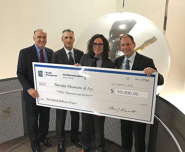 Executives from City National and RBC Wealth Management present David B. Walker (right center) from the Nevada Museum of Art with $50,000 for its support of the Orbital Reflector project.