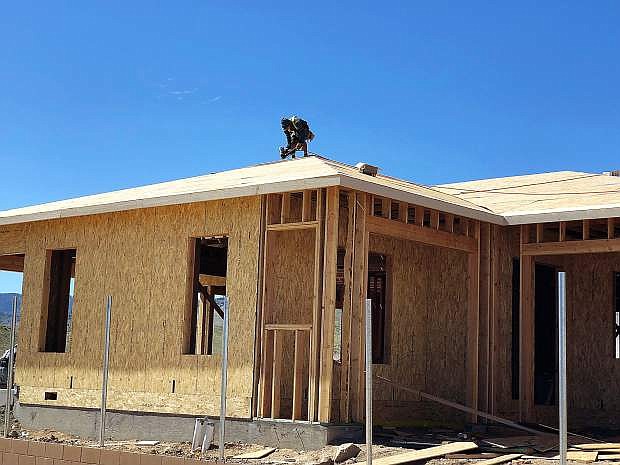 Framers nail off roof sheathing on May 9 on a home at The Pointe, a new Ryder Homes community in Somersett in Northwest Reno. According to the Builders Association of Northern Nevada, tariffs on imported framing lumber have pushed the cost of a new single-family home in Reno-Sparks up by more than $,6400.