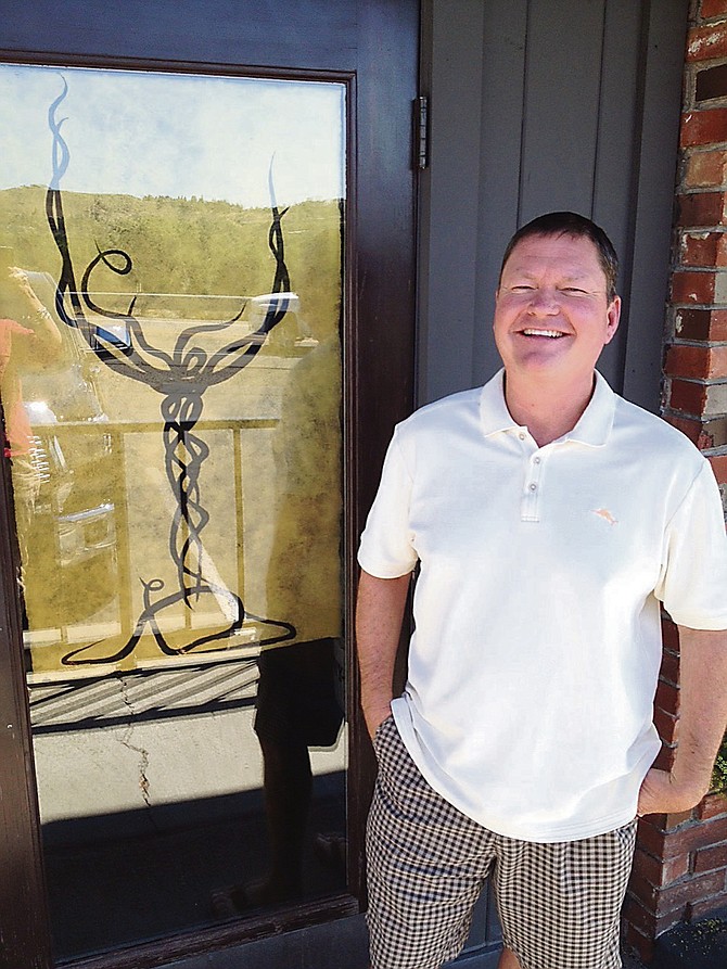Whispering Vine owner Curtis Worrall stands outside the company&#039;s branch at 4201 W. 4th St. in Reno in 2015.