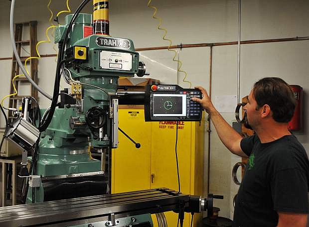WNC Machine Tool Technology instructor David Fulton familiarizes himself with one of two ProtoTRAK CNC milling machines that were donated to the college.
