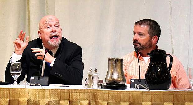Bill Anderson, left, makes a point during the July 12 Breakfast &amp; Business event, while Patrick Carr looks on.