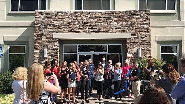 Valerie Clark, owner of Clark &amp; Associates, cuts the ribbon with the Reno + Sparks Chamber of Commerce for the company&#039;s new location on July 18 at 5470 Reno Corporate Drive.