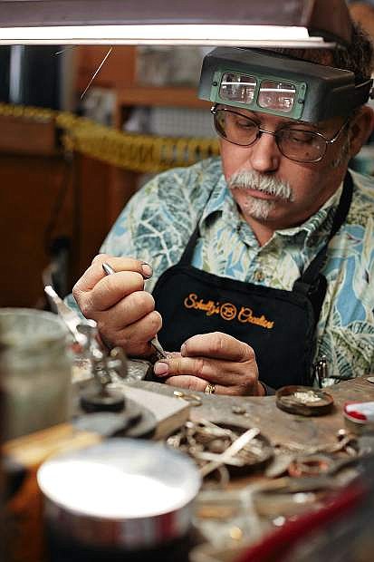 Pat Schultz works in the shop of the Sparks-based custom jewelry and repair business he owns with his wife, Terri. The Schultzs were able to grow their business after receiving a loan through the Nevada Opportunity Fund.