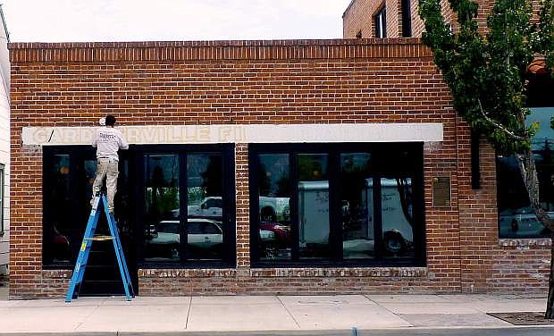 A sign-painter puts the final touches on the Gardnerville Fire Department Bar next door to the Overland in 2015.