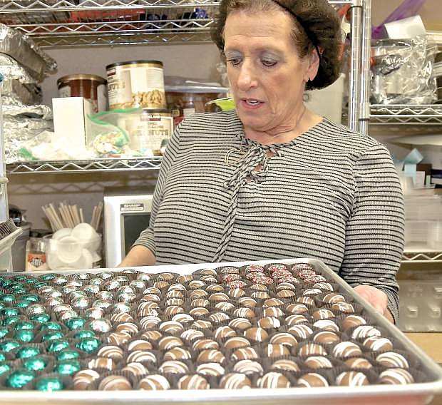 Chocolate Shoppe owner Lynn Falcone shows a tray of Christmas truffles Saturday.