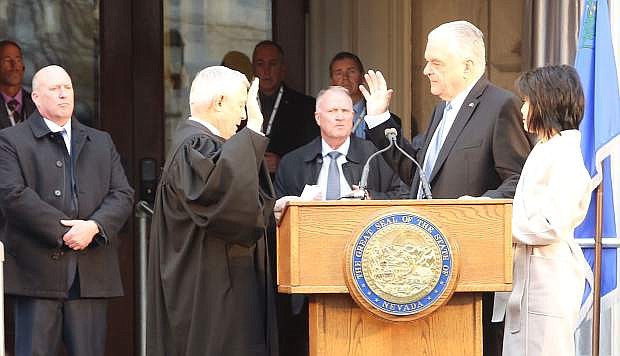 Justice Hardesty gives the Oath of Office to Gov. Steve Sisolak during Monday&#039;s inauguration.